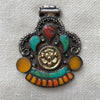 Antique looking silver and brass pendant set with amber, turquoise, and coral